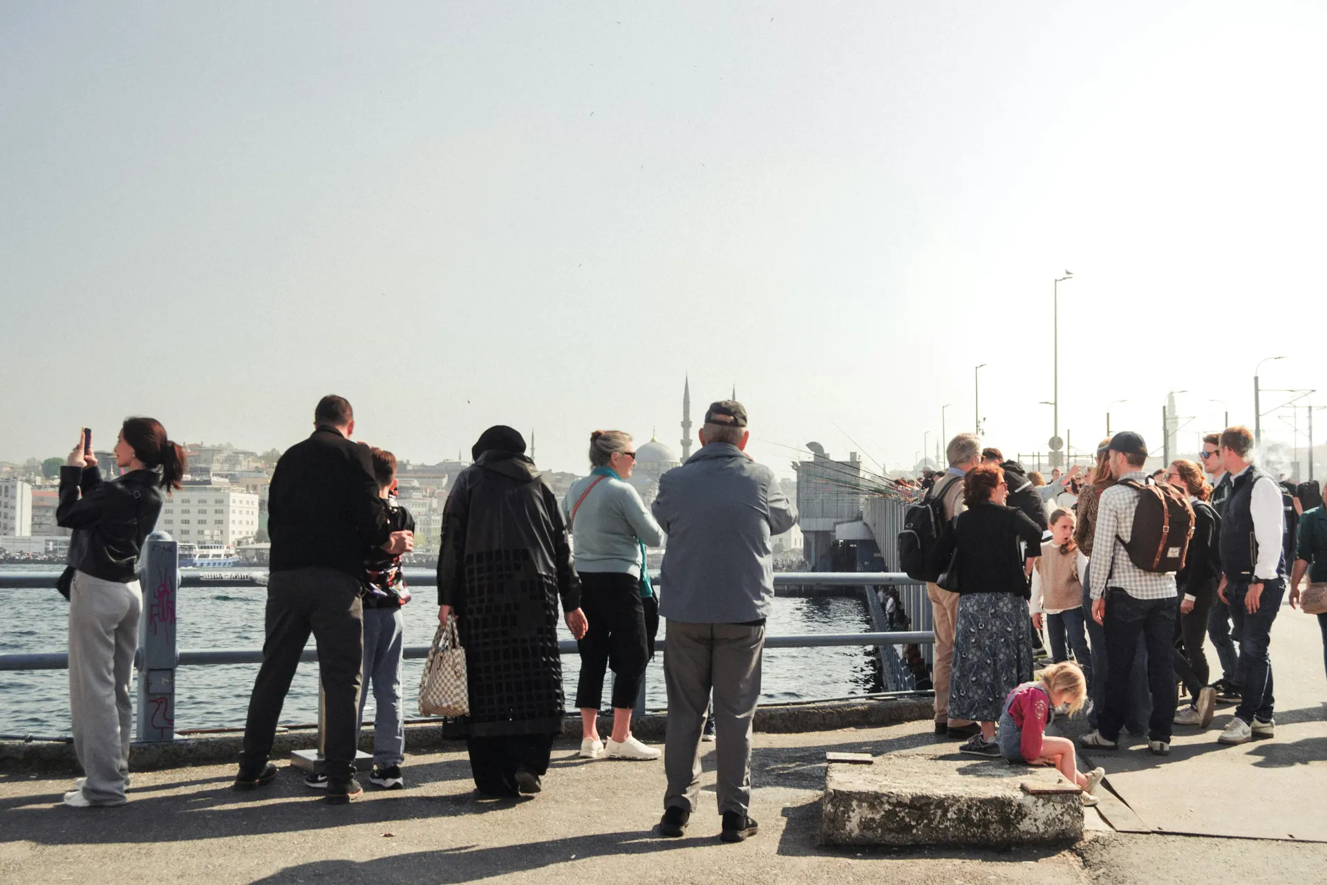 Travellers waiting beside a sunny English ferry quay