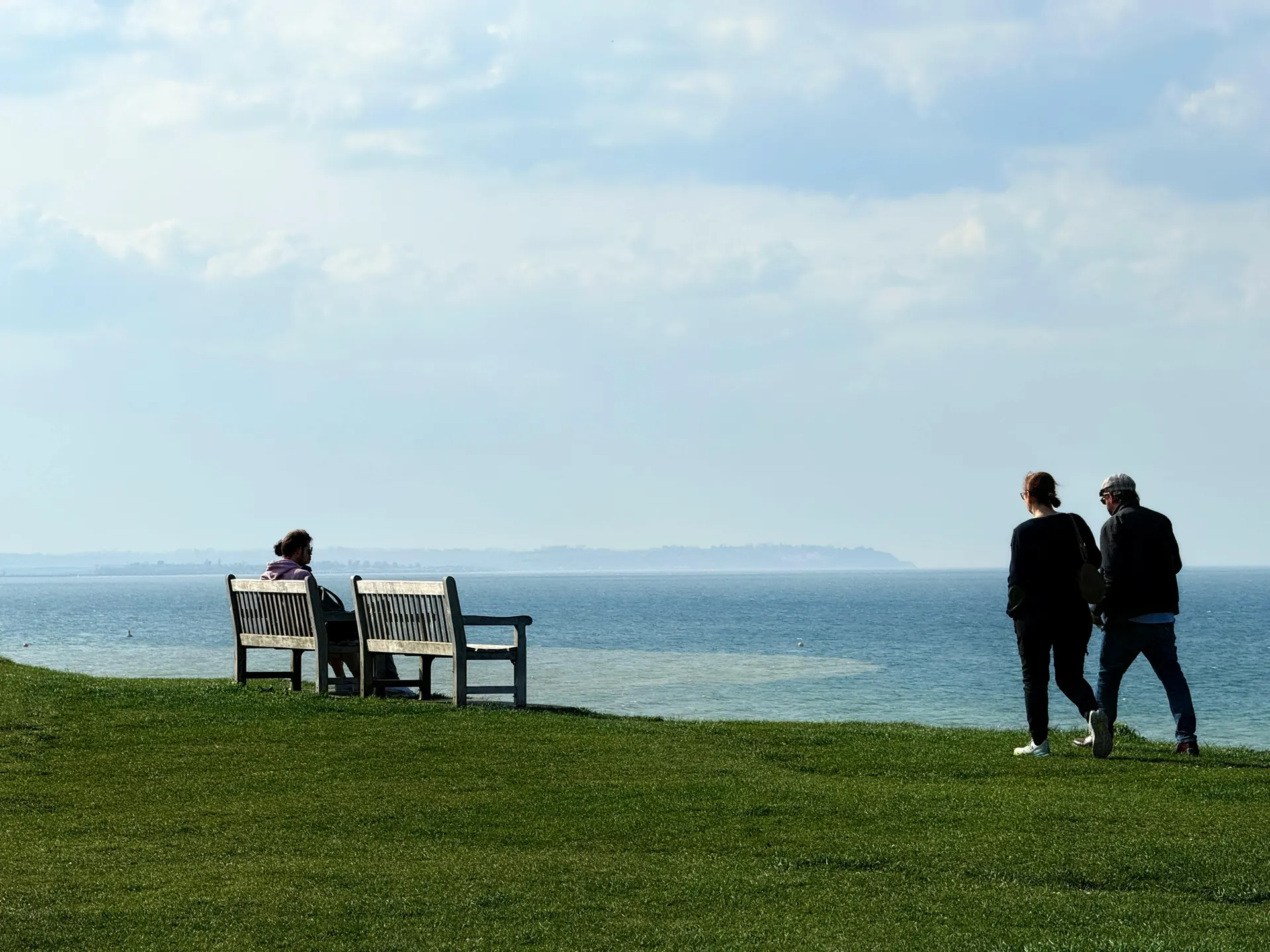 Friends crossing a colourful English seaside promenade